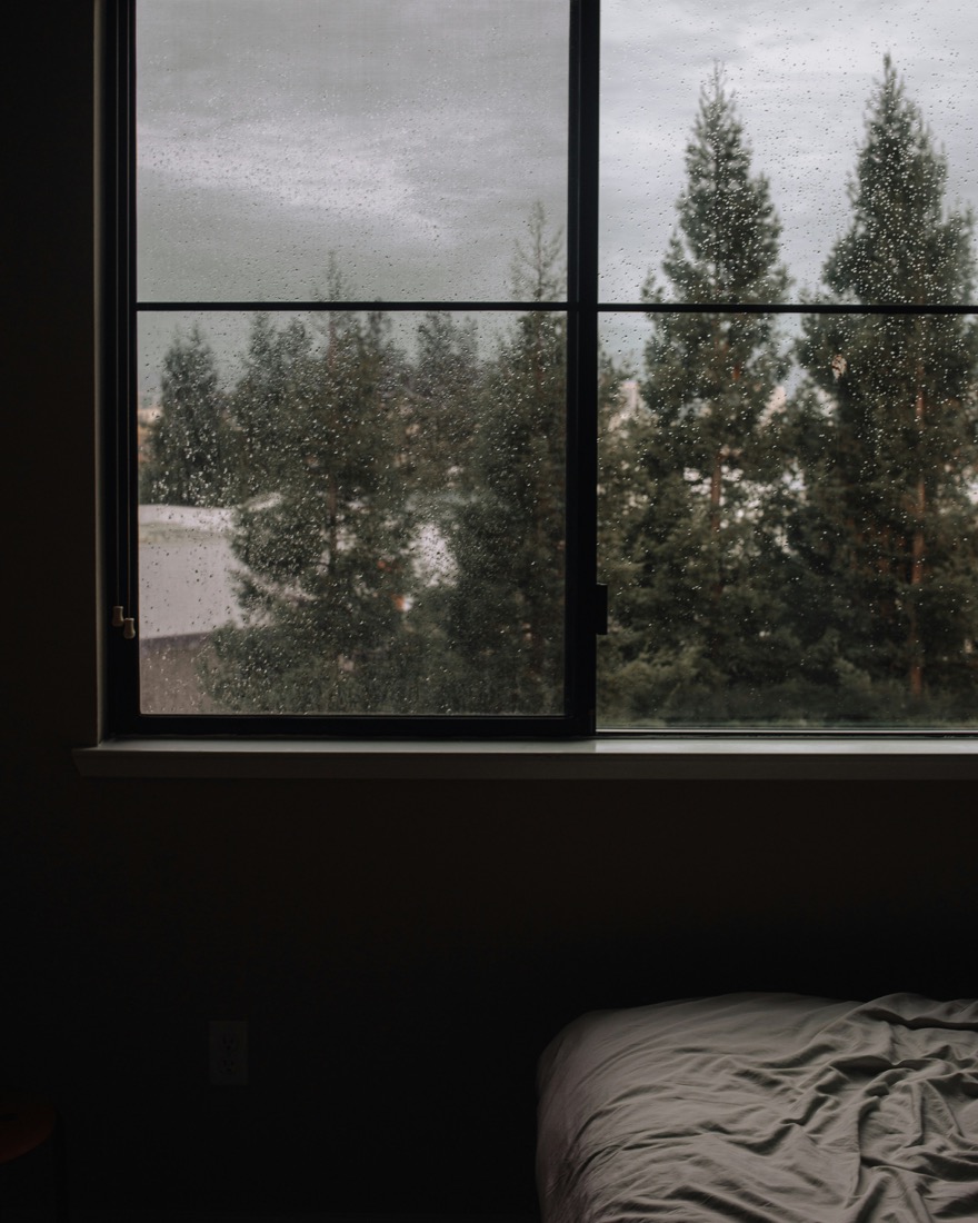A snug bedroom on a soft, rainy day