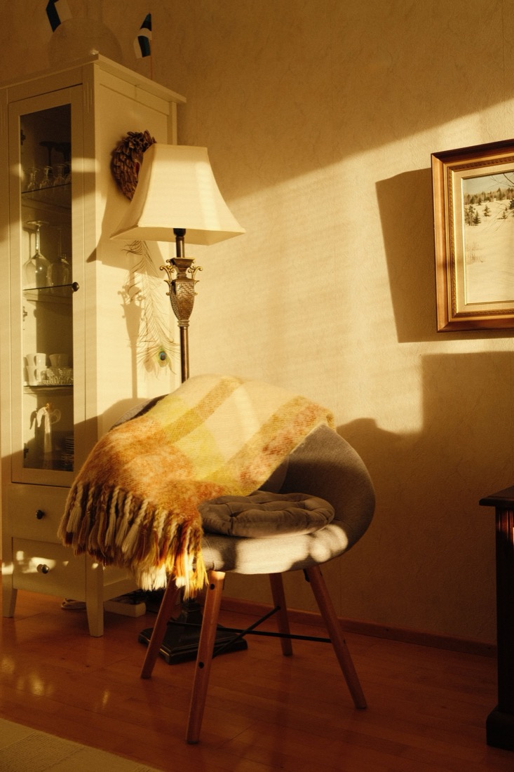 A warm reading corner lit by a single lamp