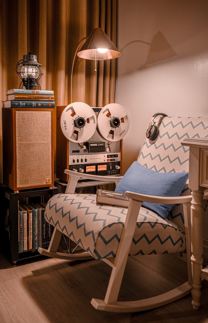 A vintage rocking chair set up as a reading nook