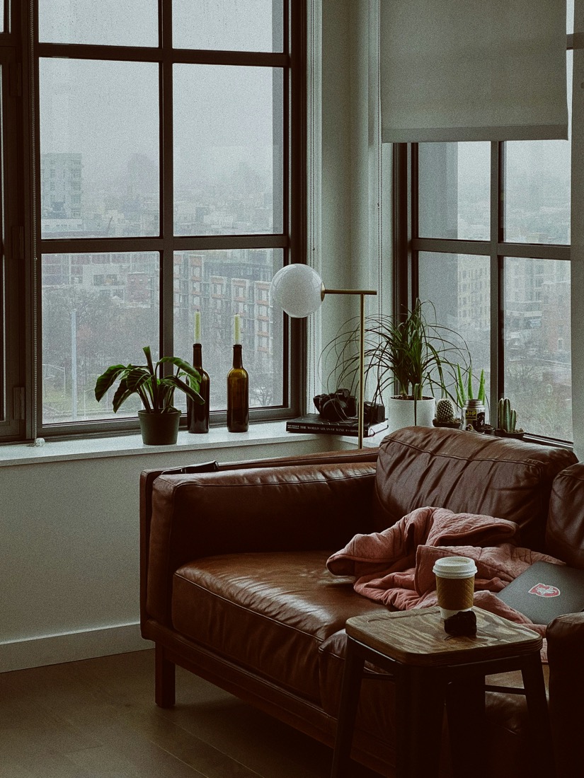 A cozy apartment living room on a rainy day