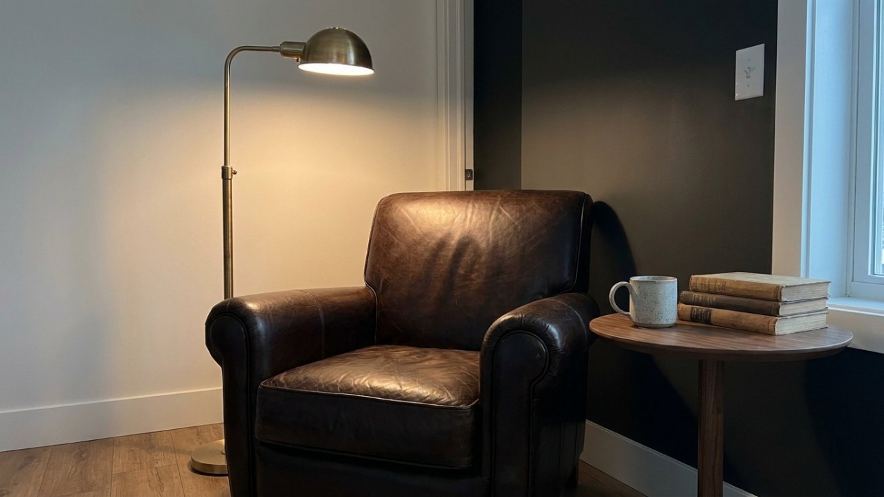 A bottle-green accent wall behind a reading corner